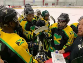  ?? ?? Members of Jamaica’s ice hockey team discuss strategy during the break in a game.