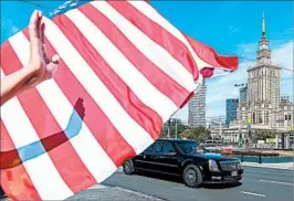  ?? JAKUB KAMINSKI/EPA ?? President Donald Trump’s limousine is greeted by people in Warsaw on Thursday as he traveled to the Royal Palace for a meeting with Polish President Andrzej Duda.