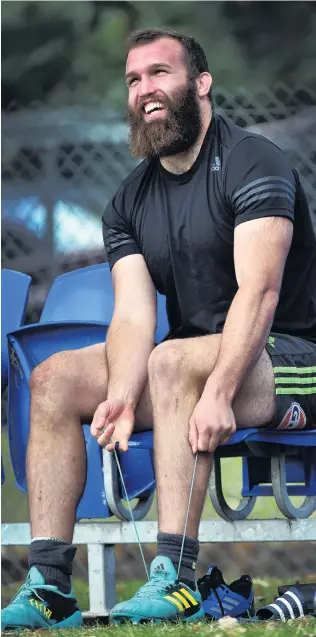  ?? PHOTO PETER MCINTOSH ?? All smiles . . . Highlander­s hooker Liam Coltman laces up his boot ahead of a training session at Logan Park yesterday.