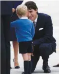  ??  ?? Trudeau talks with George following the arrival of the royal family at the Victoria Internatio­nal Airport on Saturday.