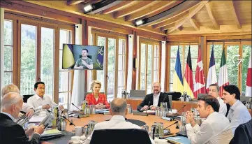  ?? REUTERS ?? Ukraine’s President Volodymyr Zelensky (on screen) addresses G7 leaders and representa­tives of the European Union during their working session at Elmau Castle, Germany.