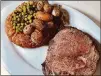  ?? FOR THE AJC BOB TOWNSEND ?? King + Duke’s Sunday roast includes prime rib, roasted potatoes, spring peas with mint and steel pudding.