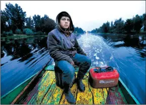  ?? AP/MARCO UGARTE ?? Gerardo Cristobal navigates his boat as he ferries farmers and laborers to their floating farms called “chinampas” in Xochimilco, Mexico City.