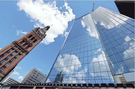  ?? MIKE DESISTI / MILWAUKEE JOURNAL SENTINEL ?? The 25-story BMO Tower is under constructi­on near Milwaukee’s City Hall. Developer Mark Irgens is focusing on employing minority-owned businesses for much of the office tower project.