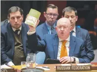  ?? AP PHOTO ?? Russian Ambassador to the United Nations Vassily Nebenzia holds up a copy of “Alice’s Adventures in Wonderland” as he speaks during a Security Council meeting on the situation between Britain and Russia Thursday.
