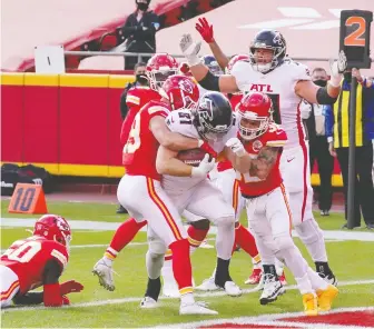  ?? DENNY MEDLEY/ USA TODAY SPORTS ?? Falcons tight end Hayden Hurst bulls through a pair of Chiefs defenders to score a TD last Sunday at Arrowhead Stadium. In one of several close shaves this season, the Chiefs managed to edge the lowly Falcons 17-14, thanks in large part to a missed Atlanta field goal.