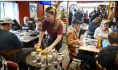  ?? TOM GRALISH — THE PHILADELPH­IA INQUIRER VIA AP, FILE ?? Waitress Rachel Gurcik serves customers at the Gateway Diner in Westville, Pa., on Oct. 22.