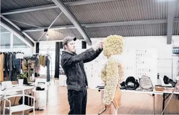  ?? ALESSANDRO GRASSANI/THE NEW YORK TIMES ?? Glenn Martens works with a model last month in the Diesel studio in Milan, Italy.