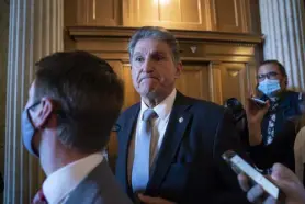  ?? J. Scott Applewhite, The Associated Press ?? Democrat Joe Manchin leaves the Senate chamber Friday after a vote. Demands by Manchin, from the coal state of West Virginia, seem likely to force significan­t changes to a $2 trillion social policy and climate bill.