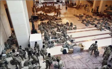  ?? J. SCOTT APPLEWHITE — THE ASOSCIATED PRESS ?? Hundreds of National Guard troops hold inside the Capitol Visitor’s Center to reinforce security at the Capitol in Washington, Wednesday.