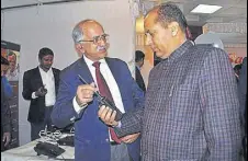  ?? DEEPAK SANSTA/HT ?? Himachal CM Jai Ram Thakur takes a look at a wireless set at the Police Science Congress in Shimla on Thursday.