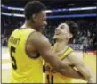  ?? GERRY BROOME — ASSOCIATED PRESS ?? UMBC’s K.J. Maura (11) and Jourdan Grant (5) celebrate the team’s 74-54 win over Virginia in a first-round game in Charlotte, N.C., Friday.