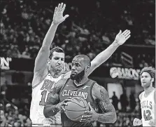  ?? [TONY DEJAK/THE ASSOCIATED PRESS] ?? Cleveland’s LeBron James started at point guard and amassed 34 points and 13 assists in Tuesday’s win over Chicago.