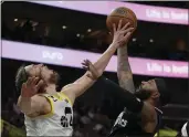  ?? RICK BOWMER — THE ASSOCIATED PRESS ?? Utah forward Kelly Olynyk, left, rejects a shot by Clippers forward Marcus Morris Sr. during the second half.