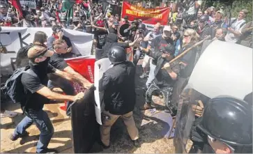  ?? Steve Helber Associated Press ?? “ALT-RIGHT,” or white nationalis­t, demonstrat­ors clash with anti-racists Saturday in Charlottes­ville, Va. President Trump referred to the latter group as the “alt-left,” which some say implies a false equivalenc­y.