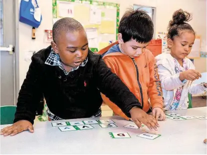  ?? Jerry Baker / For the Chronicle ?? Young pupils Elijah Fontenot, 4, left, Santiago Gamez, 4, and Lena Walt, 3, work on a spelling lesson at the Humble Head Start Center, 130 Atascocita Road in Humble. The mission of Head Start is to prepare children, whose parents are at poverty level,...