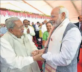  ?? PTI ?? Prime Minister Narendra Modi (right) greets the former Gujarat chief minister Keshubhai Patel at swearingin ceremony of the Vijay Rupani government on Tuesday.