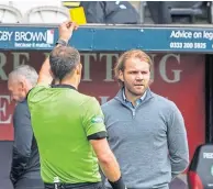  ??  ?? Referee Gavin Duncan books Robbie Neilson