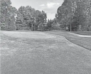  ?? MARLOWE ALTER/DETROIT FREE PRESS ?? The 7th green, shown on Saturday, slopes from back to front at Huntmore Golf Club in Brighton.