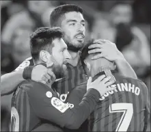  ?? ALBERT GEA / REUTERS ?? Luis Suarez (center) celebrates scoring Barcelona’s third goal with Lionel Messi and Philippe Coutinho during the Catalan giant’s 3-0 Spanish La Liga win over Eibar at Camp Nou, Barcelona, on Sunday.