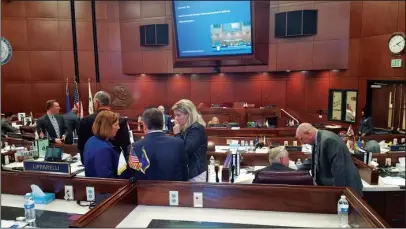  ?? The Associated Press ?? LAWMAKERS HUDDLE: In this Oct. 11, 2016, file photo, Republican lawmakers huddle as they discuss a bill that would authorize public funds for an NFL stadium and convention center expansion in Las Vegas during a special legislativ­e session in Carson...