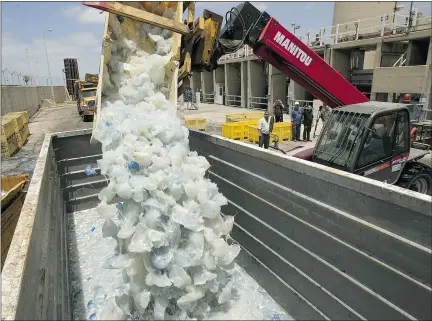  ?? — GETTY IMAGES FILES ?? A digger dumps jellyfish cleared from the power station in Hadera, Israel, after they blocked the water supply used to cool the plant in 2011 in the coastal city north of Tel Aviv.