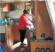  ?? ?? Julie Giddings ensures the crockery, cutlery, galley and saloon area are spick and span well before the next boat hirers board the vessel.