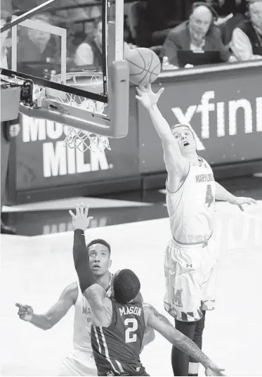  ?? ULYSSES MUÑOZ/BALTIMORE SUN ?? Maryland guard Kevin Huerter, right, blocking a shot against Minnesota at Xfinity Center, is averaging 14.2 points and 5.5 rebounds a game for the Terps. The sophomore has started all 22 games for the Terps this season.