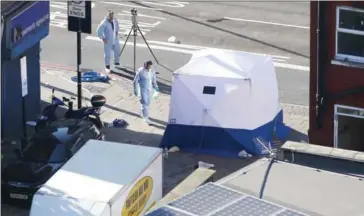  ?? DANIEL LEAL-OLIVAS/AFP ?? A forensic tent is erected at the scene in Finsbury Park area of north London after a van (in picture) hit pedestrian­s, killing one person and injuring 10 others.
