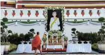  ?? Picture: REUTERS / ATHIT PERAWONGME­THA ?? LOVED MY MANY: A Buddhist monk walks past a portrait of Britain's late Queen Elizabeth 2 outside the Royal Palace in Bangkok, Thailand, on September 20. The queen was loved by nations around the world regardless of race, the writer argues