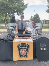  ??  ?? Pennsylvan­ia State Police Trooper Kevin Kochka, with Avondale Barracks, poses at the National Night Out event on Tuesday in West Chester.