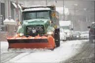  ?? Erik Trautmann / Hearst Connecticu­t Media ?? DPW plow trucks deal with the snow on Washington Street in Norwalk on Jan. 18.