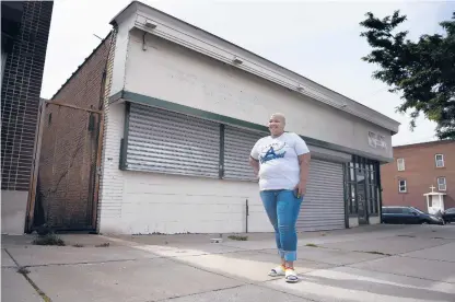  ?? JESSICA HILL/SPECIAL TO THE COURANT ?? Jendayi Scott-miller stands outside the future site of the Angel of Edgewood Community Cafe and Resource Center in Hartford. Scott-miller, who provides people in need with meals and groceries through the nonprofit, is opening a food pantry and soup kitchen.