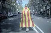  ?? PICTURE: AP ?? A man draped in an independen­ce flag walks outside the Catalan parliament, in Barcelona, Spain, on Thursday.