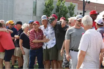  ?? Amp. (Caitlan Butler/News-Times) ?? Current and former refinery workers hug during a centennial celebratio­n for the El Dorado refinery held Saturday at the MAD