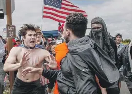  ?? Irfan Khan Los Angeles Times ?? LAST SPRING, supporters of President Trump scuff led with anti-Trump protesters in Huntington Beach during a “Make America Great Again” march.