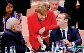  ??  ?? Prime Minister Narendra Modi with German Chancellor Angela Merkel and French President Emmanuel Macron during the G20 Leaders’ Summit in Hamburg, Germany, on 7 July 2017.