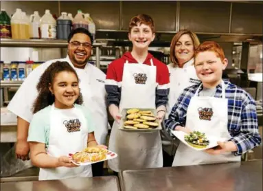  ?? SUBMITTED PHOTO ?? Jarrett Young, rear left, and Maria Crann, rear right, with a few junior chefs showing off their creations.