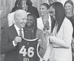  ?? SAUL LOEB/AFP VIA GETTY IMAGES ?? President Joe Biden, with Aces player A'ja Wilson, holds up a jersey given to him by the team during an event to recognize the 2023 WNBA Champions Las Vegas Aces, in the East Room of the White House in Washington, DC on May 9.