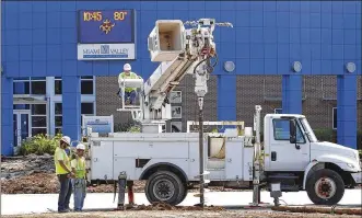  ?? TY GREENLEES / STAFF ?? A new lamp is installed at the Miami Valley Career Technology Center’s entrance as part of upgrades and expansion this summer. A bond issue/tax levy was passed in 2017 for a five-year campus makeover to establish one building, instead of the current multiple buildings, for safety concerns.