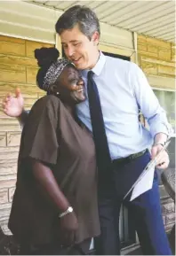  ?? STAFF PHOTO BY TIM BARBER ?? Mayor Andy Berke receives a hug from Kelly Langston following a talk with her about new employment opportunit­ies under the Workforce Outreach Program.