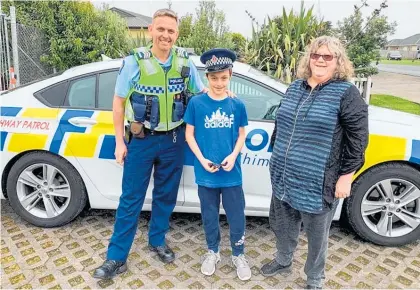  ?? Photo / Supplied ?? Ryan Farelly, 10, with nana Kathie and Sergeant Fleming in Pokeno yesterday.