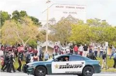  ?? AP ?? Police patrolled outside Marjory Stoneman Douglas High School where Nikolas Cruz killed 17.