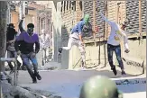  ?? AFP PHOTO ?? Protesters clash with policemen in Srinagar on Sunday following gunfights between militants and security personnel.