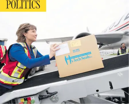  ?? JONATHAN HAYWARD / THE CANADIAN PRESS ?? B.C. Liberal Leader Christy Clark loads boxes on to a plane as she makes a campaign stop in Richmond, B.C., on Monday.