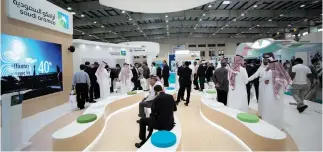  ??  ?? Visitors are seen at the Saudi Aramco stand at an exhibition in Manama. The oil giant has become increasing­ly active in startup funding. (Reuters)