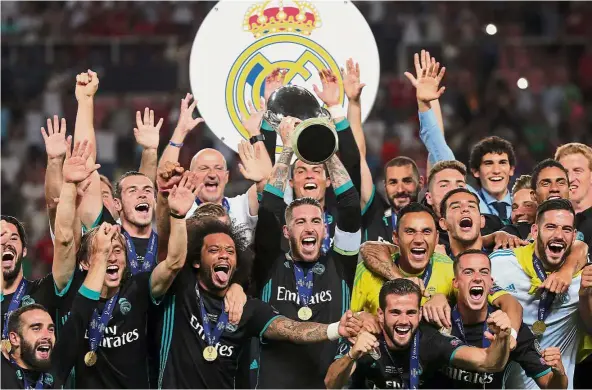  ??  ?? Spaniards rule again: Real Madrid players, led by captain Sergio Ramos, celebratin­g after winning the UEFA Super Cup on Tuesday. — Reuters