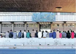  ?? ?? PEOPLE queue outside the Refugee Reception Office in Cape Town. Our problems with bureaucrac­y arise, not from the bureaucrac­y itself, but from the government (elected or otherwise) that creates more programmes and regulation­s for the bureaucrac­y to manage and to be enforced. | African News Agency (ANA) archives