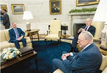  ?? DOUG MILLS/THE NEW YORK TIMES ?? President Joe Biden meets with congressio­nal leaders on the looming debt crisis Tuesday in the Oval Office. With Biden are House Speaker Kevin McCarthy, seated left, and Senate Majority Leader Chuck Schumer.