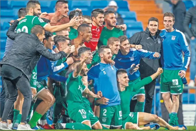  ??  ?? TOMARON EL BERNABÉU. Los jugadores del Leganés se quedaron a pie de campo tras el partido celebrándo­lo con la afición y con los familiares que acudieron al estadio.